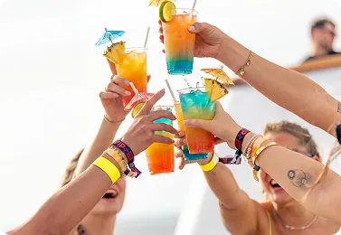 Cocktails raised together in a toast on board