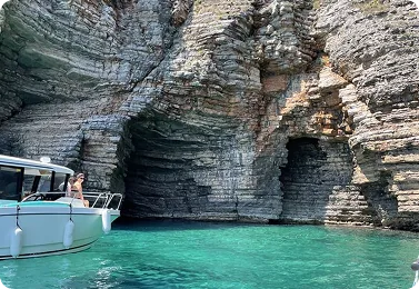 A boat entering a sea cave in the coastal cliffs